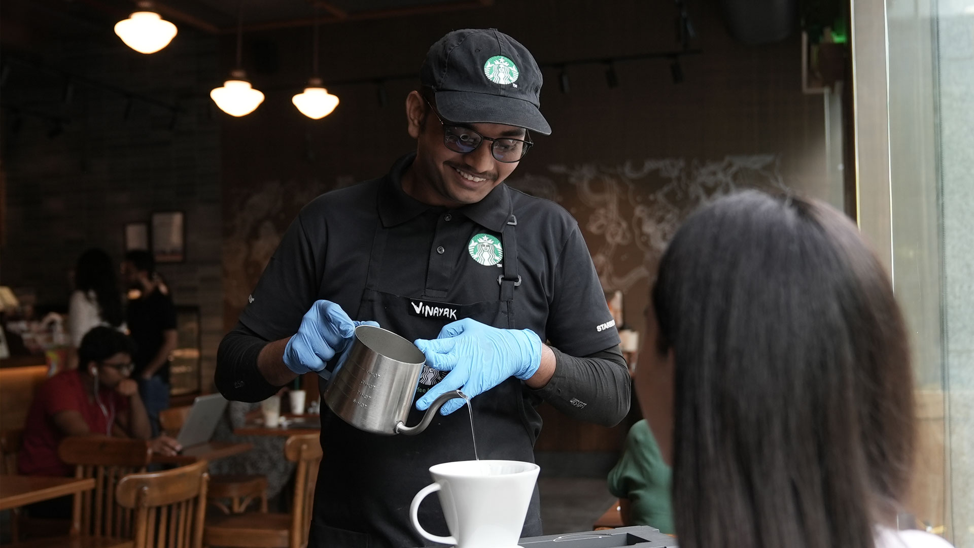 A barista demonstrates the art of serving coffee
