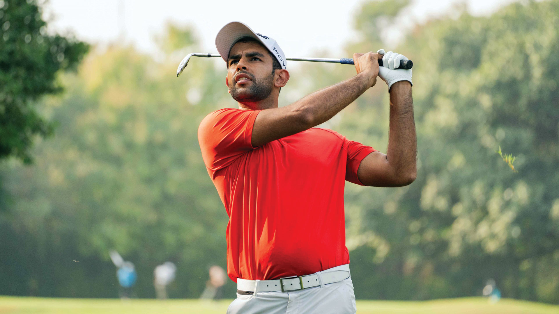 A golfer tees off