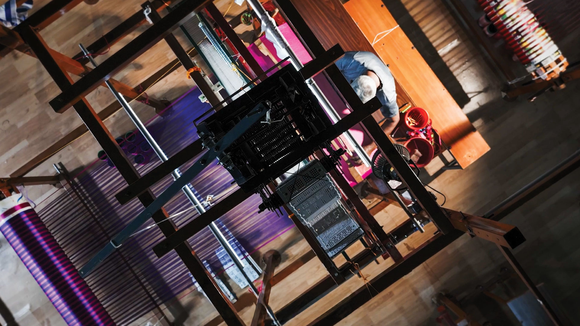 a top view of an artisan working on a mechanised and ergonomic loom
