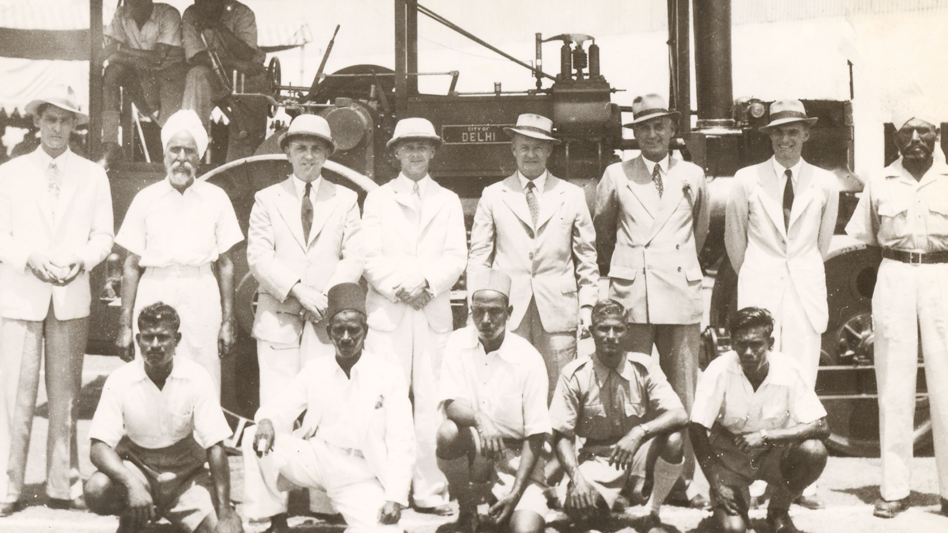 People in front of a road roller